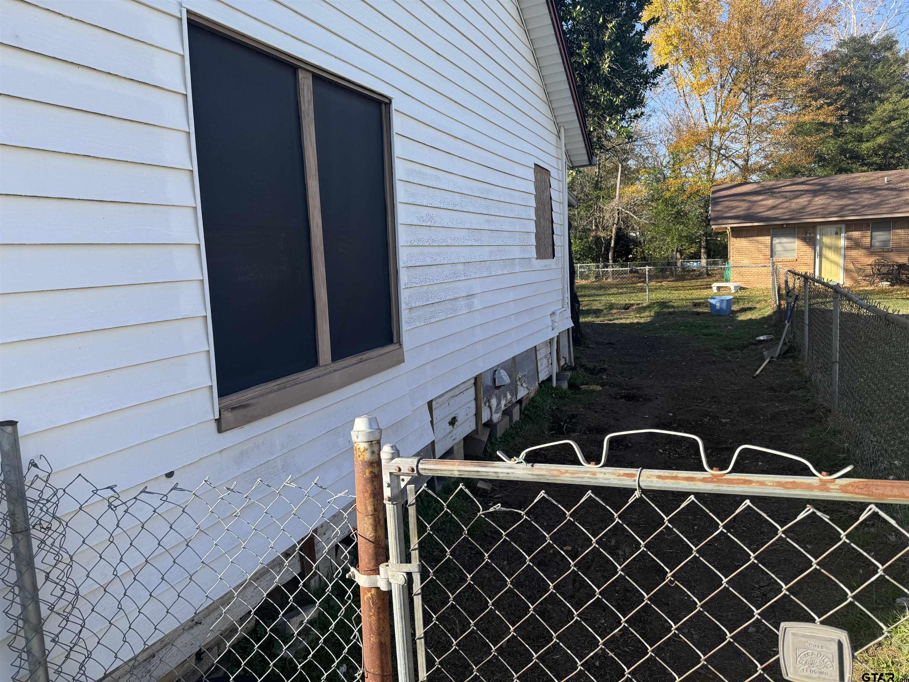 103 Mallory Street Lindale, TX 75771 - Photo 5 of 10 a view of a door and a table in the patio