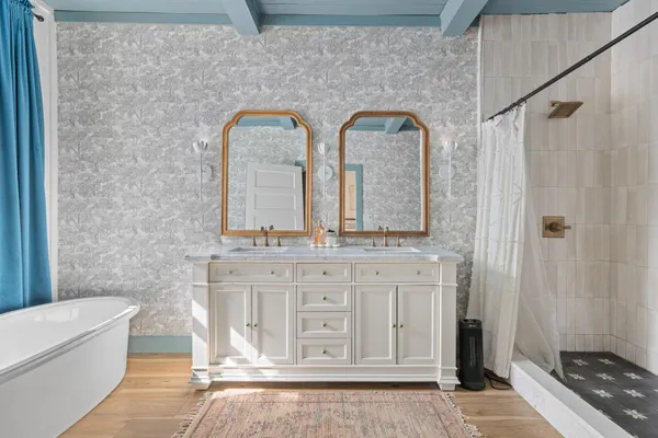 a white bath tub sitting next to a white sink
