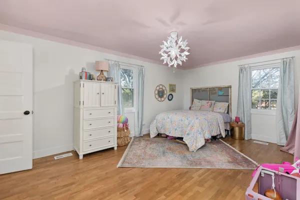 a bedroom with a bed and a chandelier