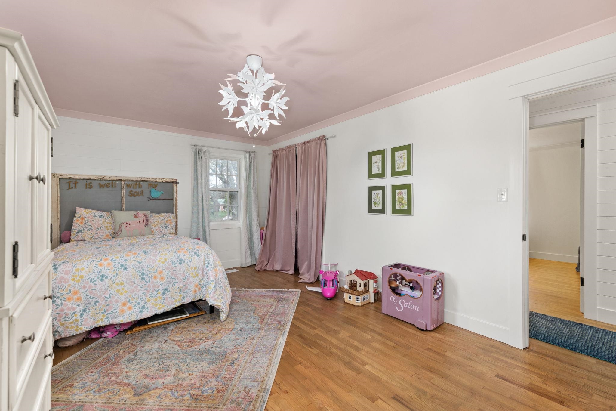 41 County Road 409 Rienzi, MS 38865 - Photo 21 of 40 Bedroom featuring light wood-type flooring and a chandelier
