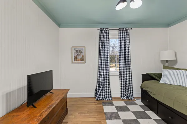 a bedroom with a bed and a window