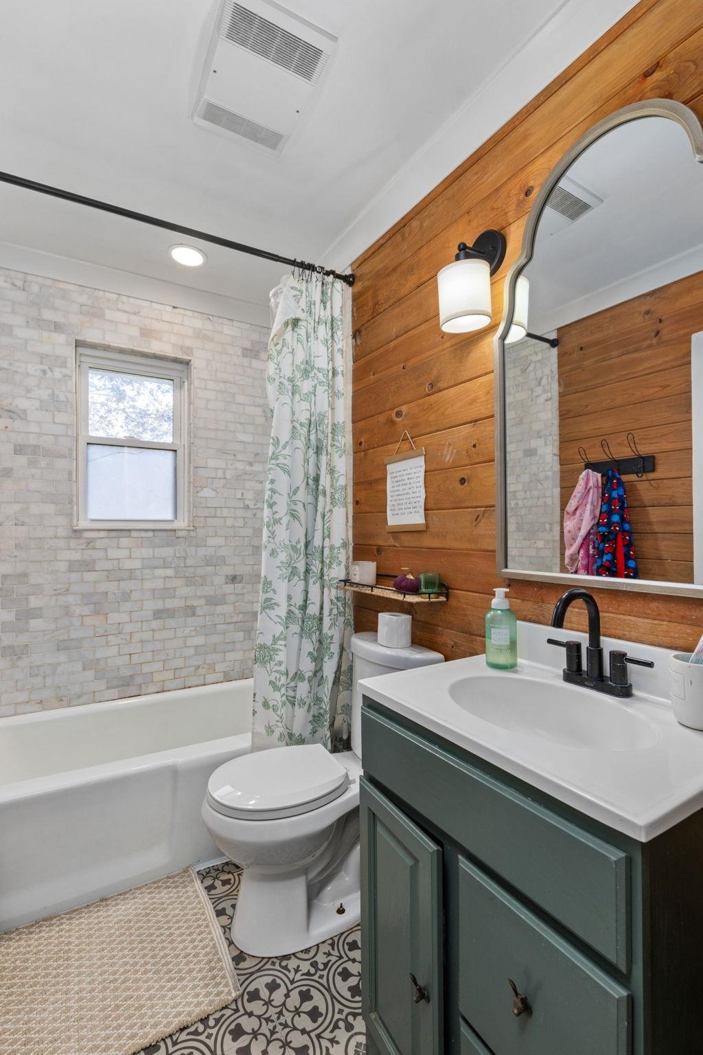 41 County Road 409 Rienzi, MS 38865 - Photo 28 of 40 Bathroom featuring vanity, shower / tub combo with curtain, wooden walls, recessed lighting, and tile patterned flooring