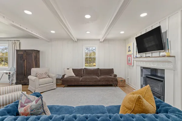 a living room with furniture fireplace and flat screen tv