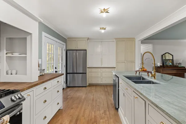 a kitchen with a refrigerator and a sink