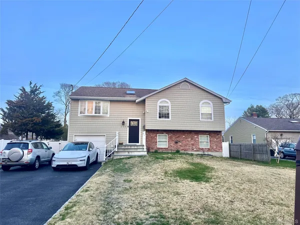 a view of house with backyard space and wooden fence
