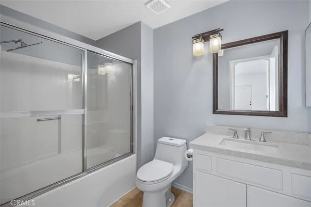 a bathroom with a toilet sink and shower