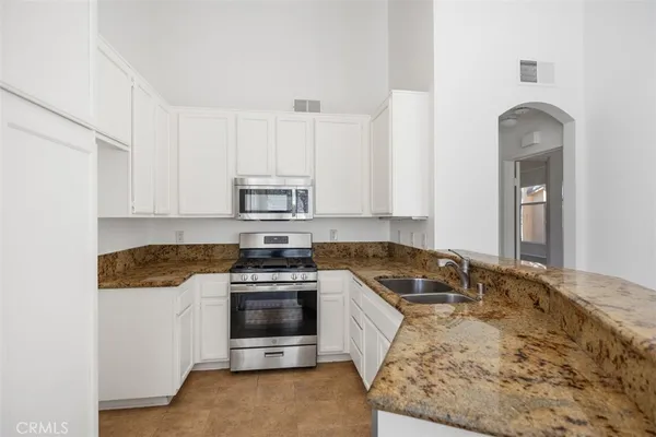 a spacious bathroom with a double vanity sink and mirror
