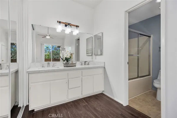 a bathroom with a double vanity sink and a mirror
