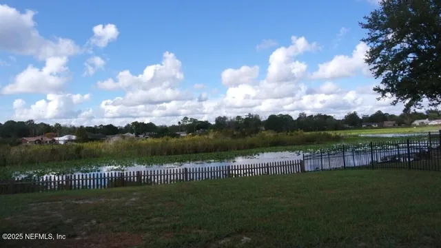 a view of a lake with a big yard