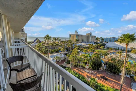a view of a balcony with wooden benches