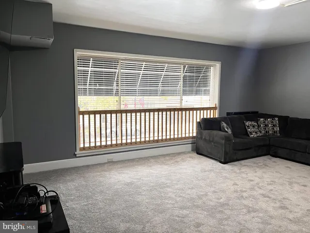 a living room with a couch and a window