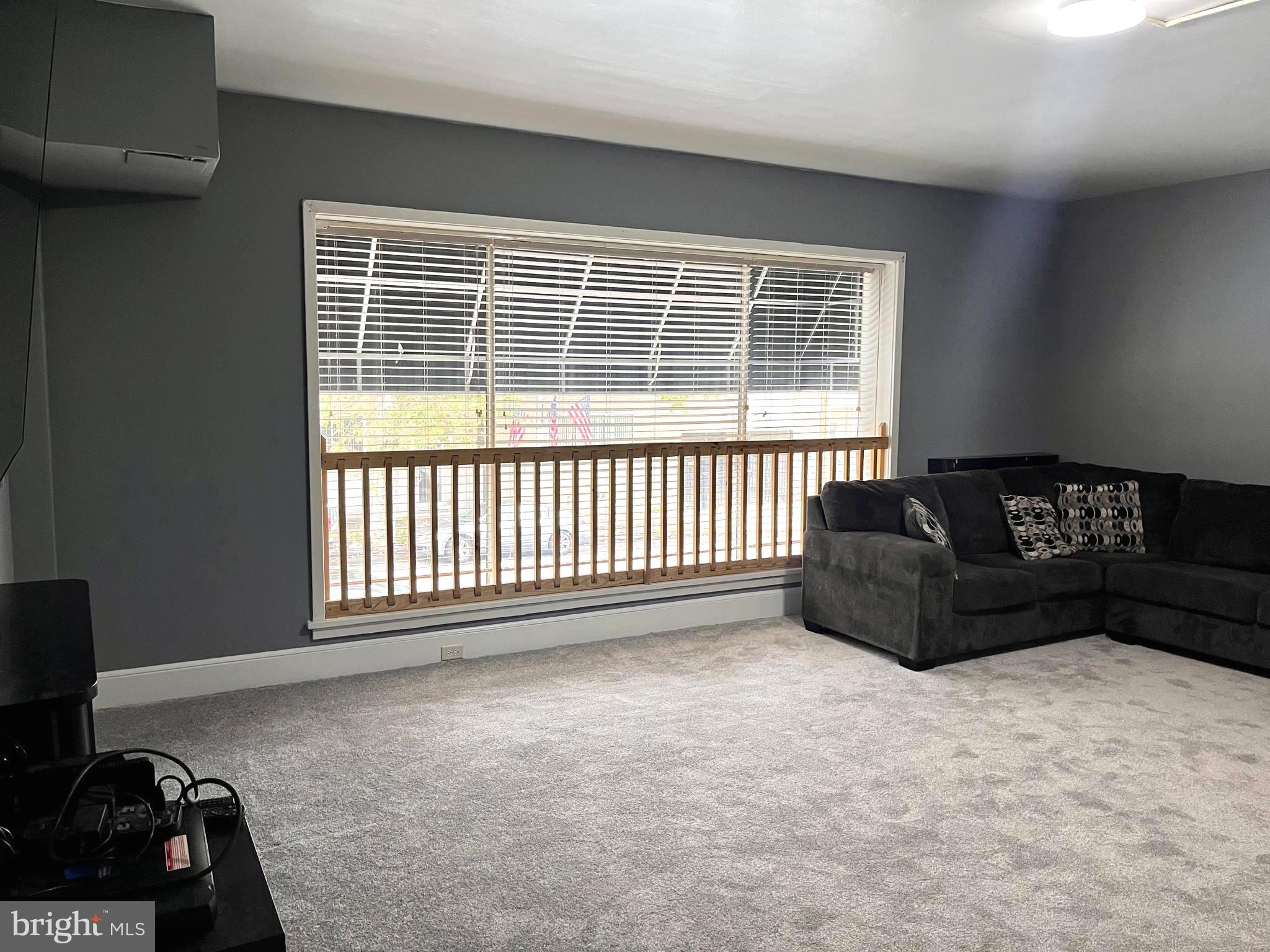 a living room with a couch and a window