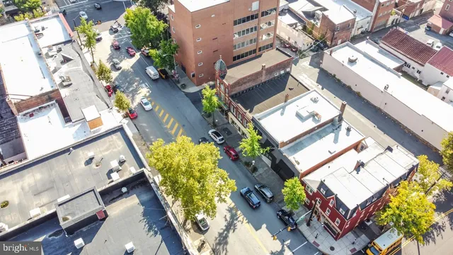 an aerial view of residential houses with outdoor space and parking