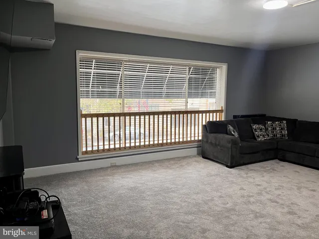 a living room with a couch and a window