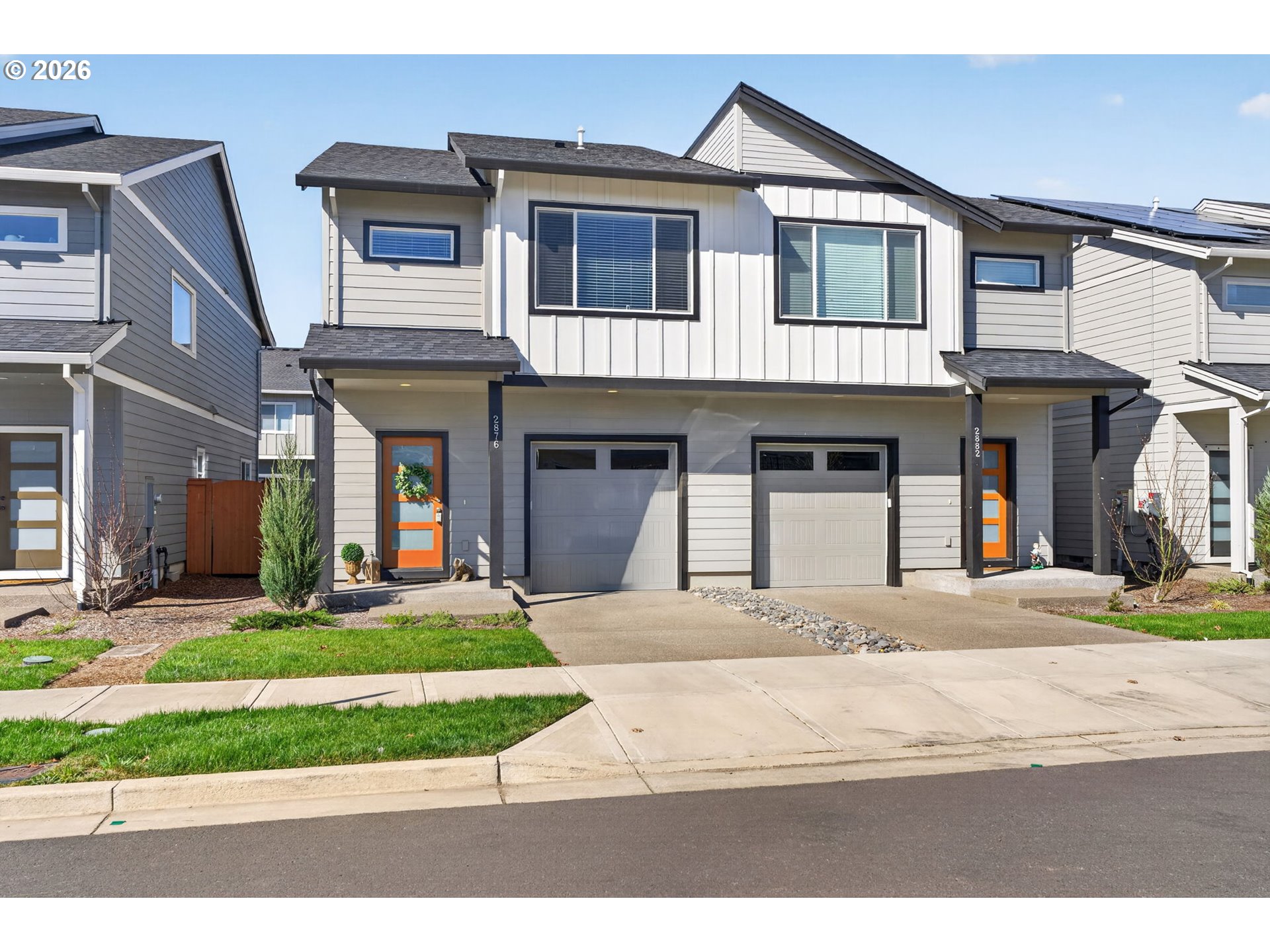 a front view of a house with garden and plants