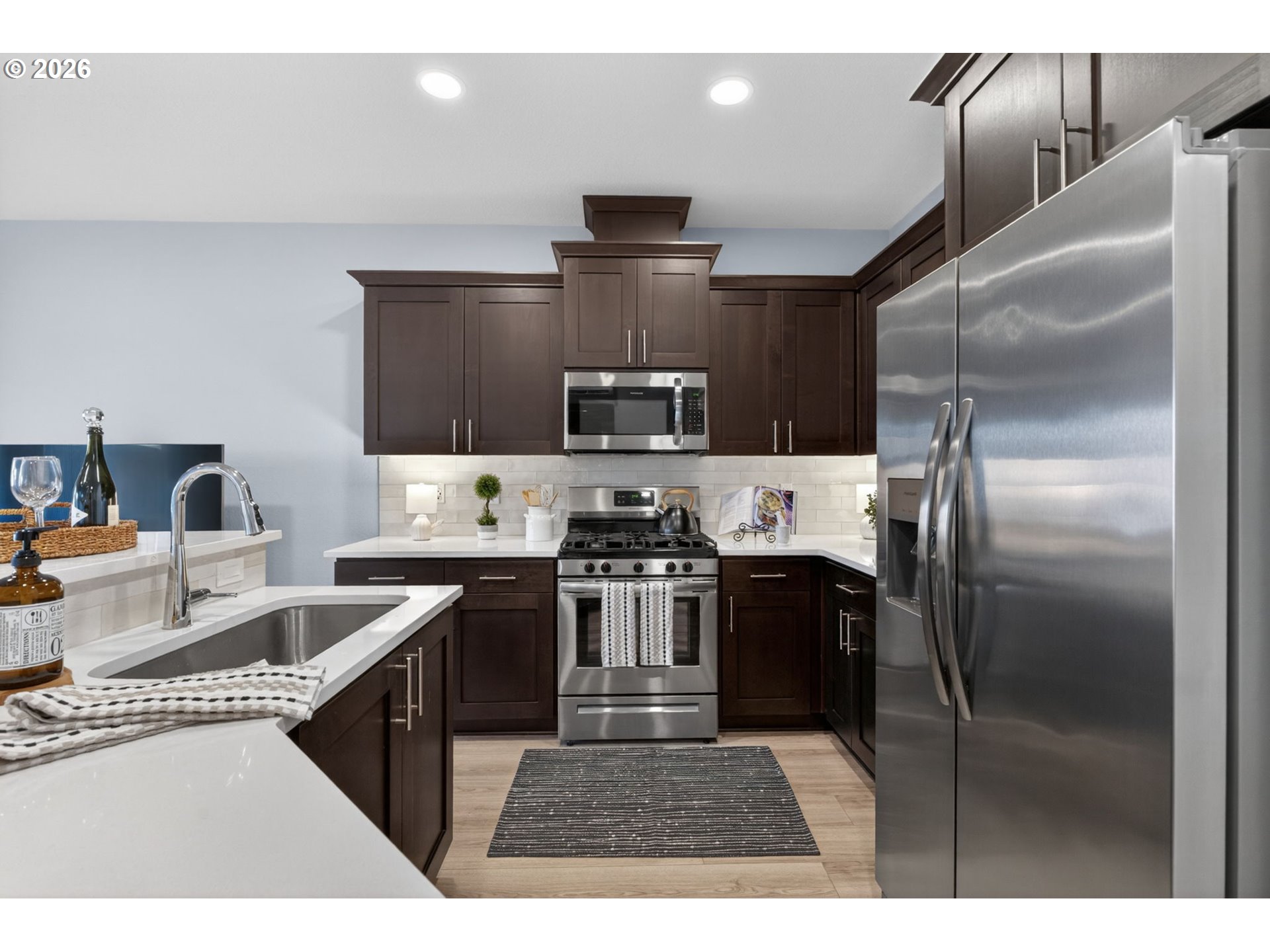 2876 South Nectarine Street Cornelius, OR 97113 - Photo 6 of 42 a kitchen with kitchen island a counter space a sink appliances and cabinets