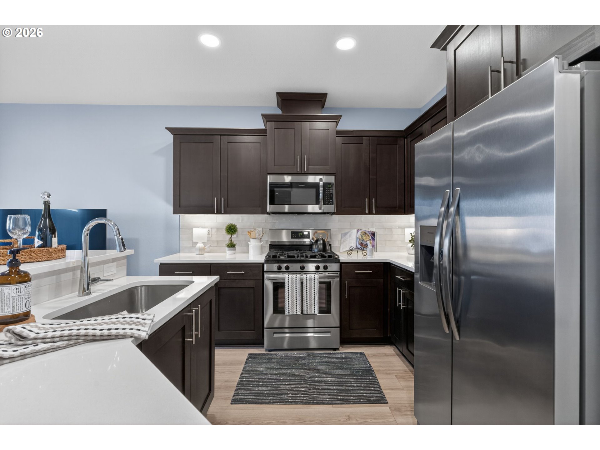2876 South Nectarine Street Cornelius, OR 97113 - Photo 7 of 42 a kitchen with kitchen island a counter space a sink appliances and cabinets