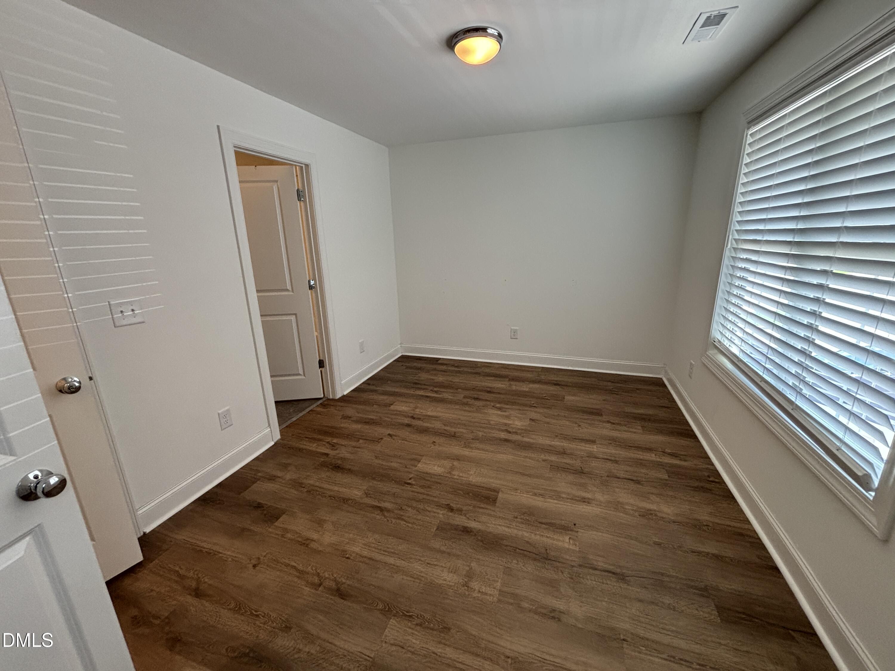 5710 Parker Pnes Court Raleigh, NC 27609 - Photo 63 of 78 an empty room with wooden floor and windows