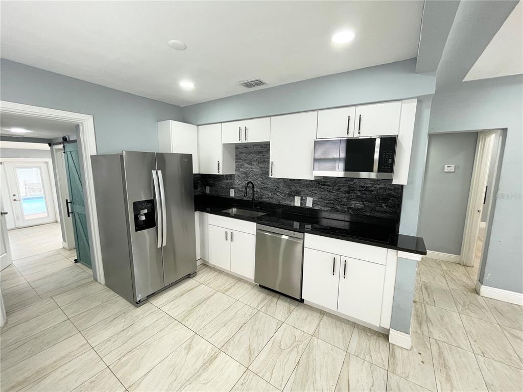 3428 Ithaca Street North St. Petersburg, FL 33713 - Photo 6 of 22 a kitchen with stainless steel appliances a refrigerator and a stove