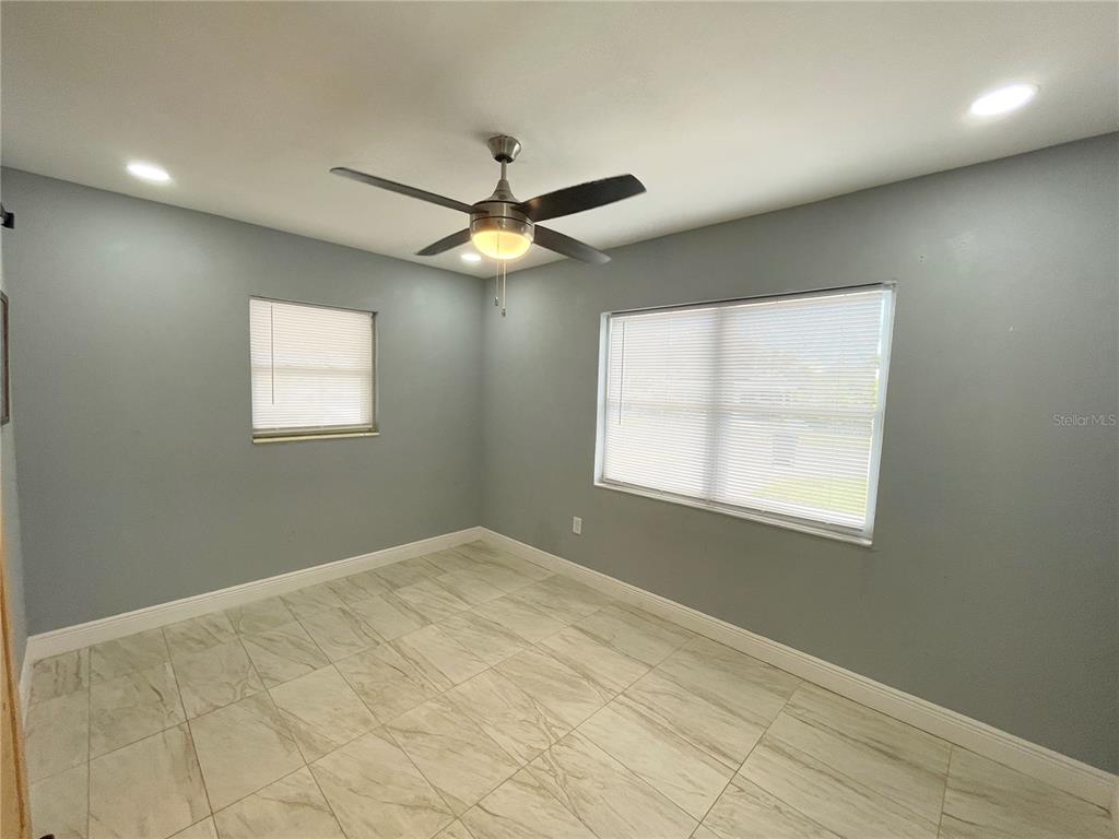 3428 Ithaca Street North St. Petersburg, FL 33713 - Photo 7 of 22 an empty room with windows and fan