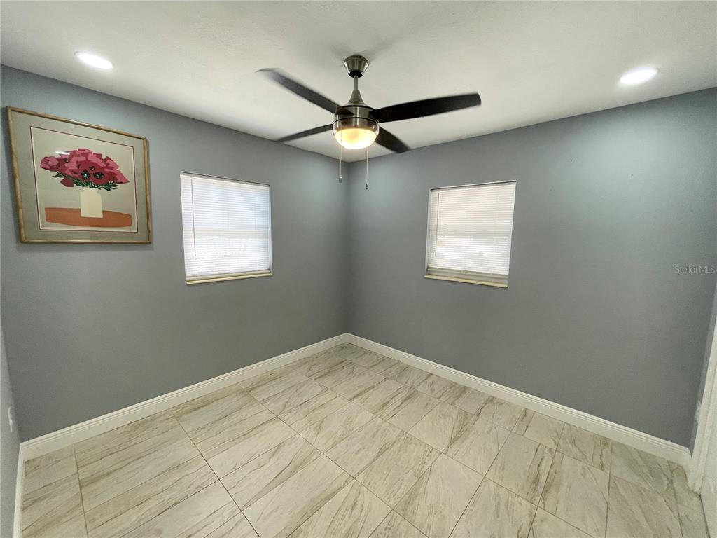 3428 Ithaca Street North St. Petersburg, FL 33713 - Photo 9 of 22 an empty room with windows and fan