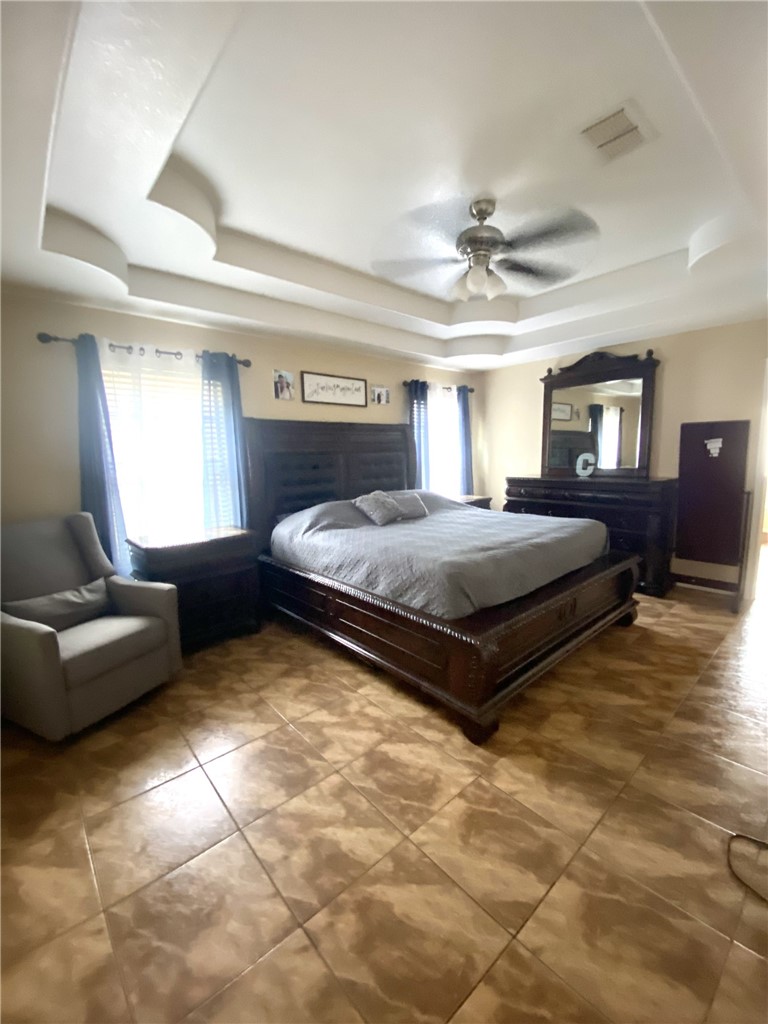 1250 Lawrence Trail Alice, TX 78332 - Photo 23 of 40 a bedroom with a bed and a couch