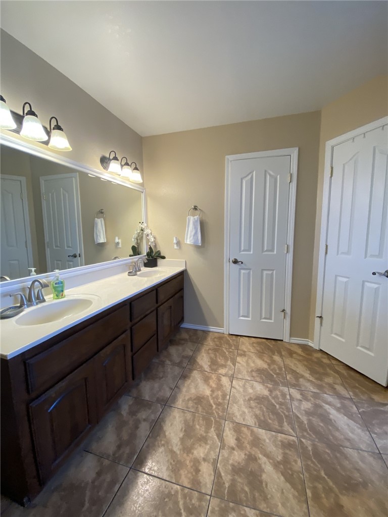 1250 Lawrence Trail Alice, TX 78332 - Photo 26 of 40 a bathroom with a sink vanity and mirror