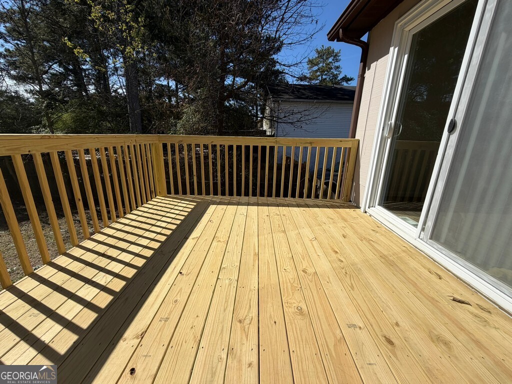 9292 Settlers Grove Road Northeast Covington, GA 30014 - Photo 102 of 110 a view of balcony with wooden floor and fence