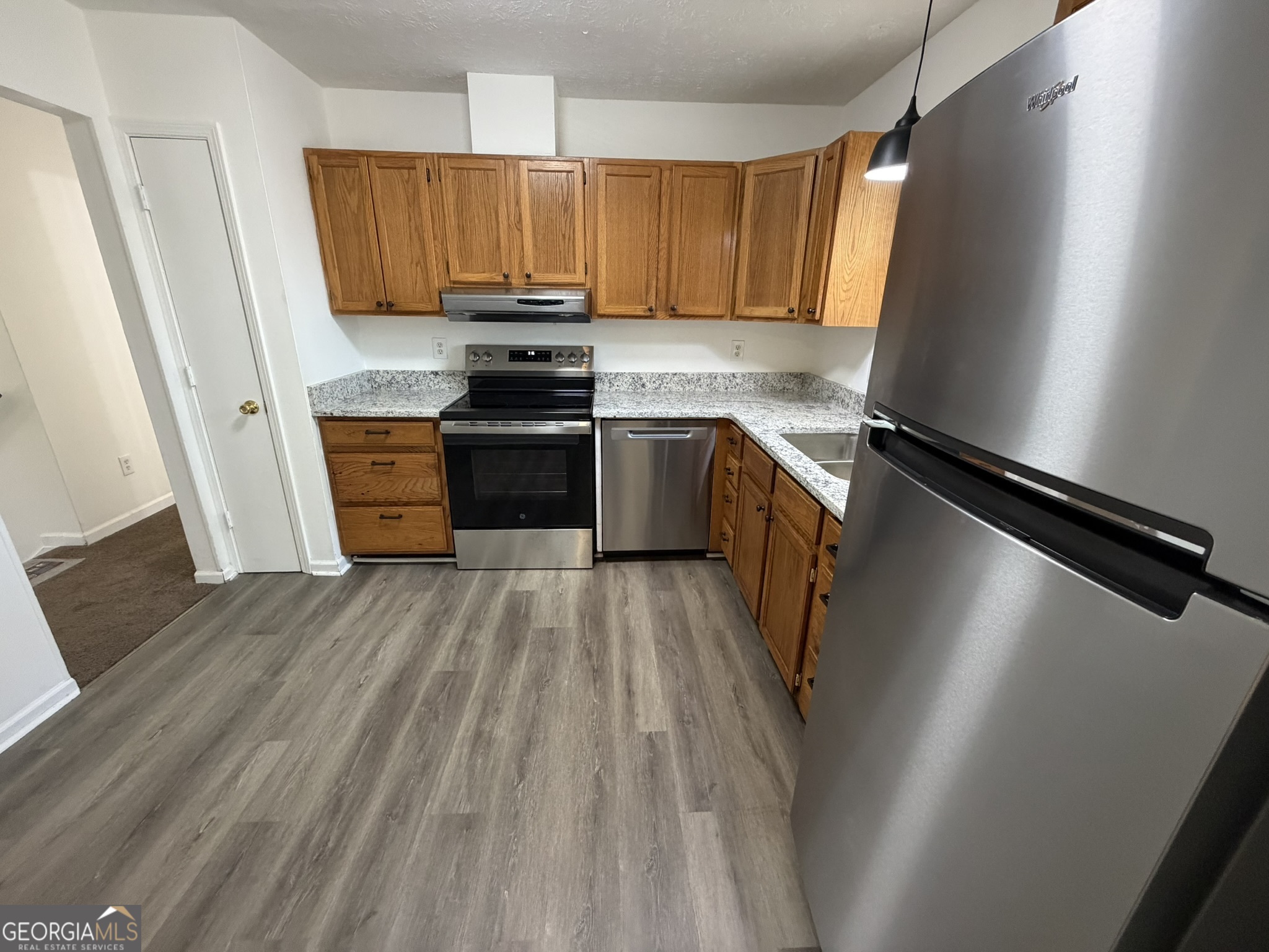 9292 Settlers Grove Road Northeast Covington, GA 30014 - Photo 16 of 110 a kitchen with a refrigerator stove and sink