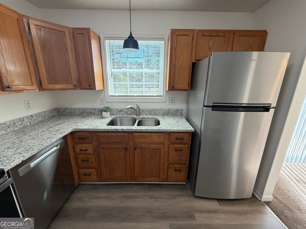 9292 Settlers Grove Road Northeast Covington, GA 30014 - Photo 17 of 110 a kitchen with stainless steel appliances granite countertop a refrigerator a sink a stove a washer and dryer