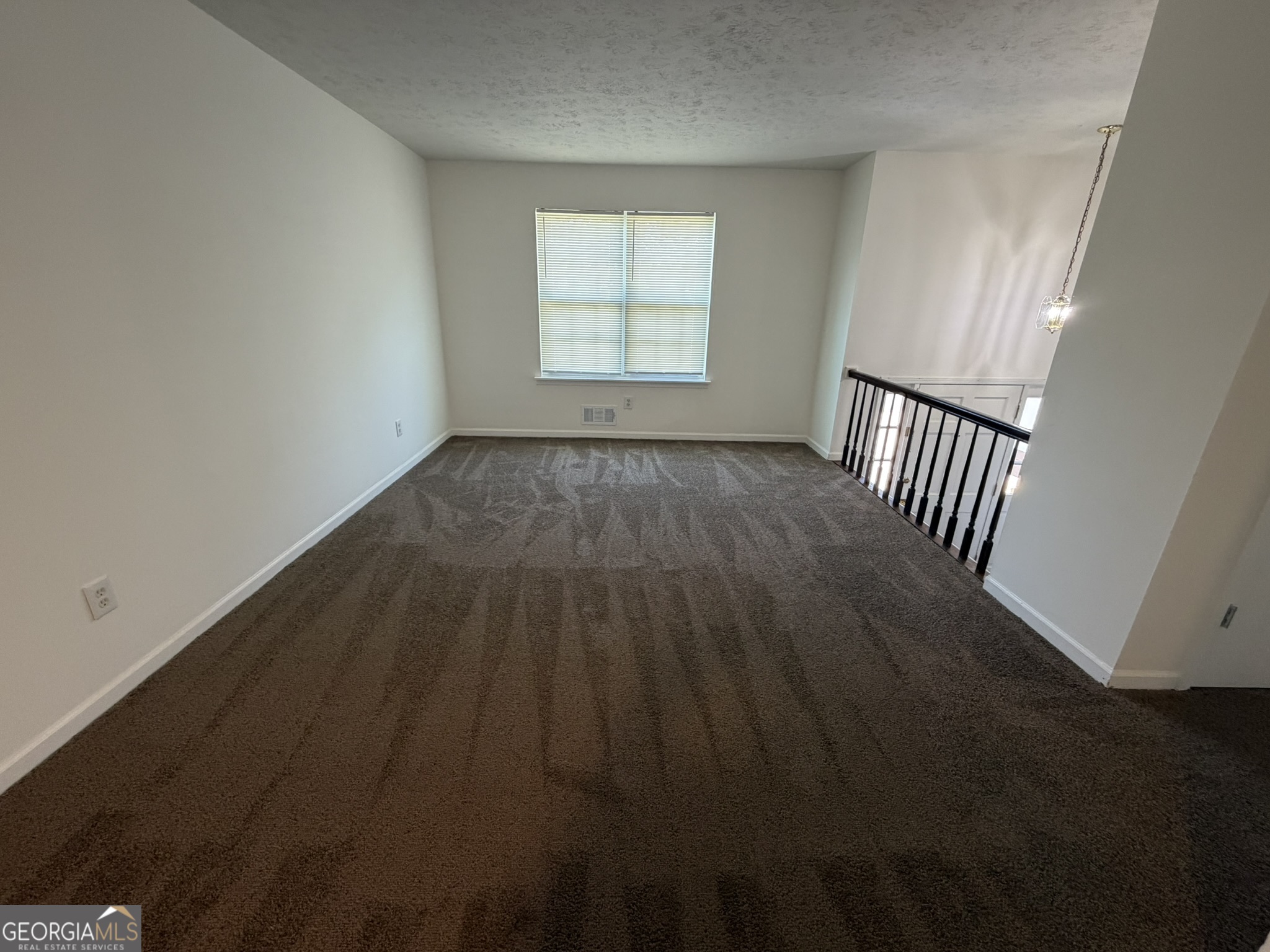 9292 Settlers Grove Road Northeast Covington, GA 30014 - Photo 2 of 110 an empty room with wooden floor and windows