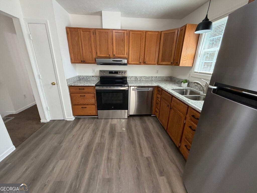 9292 Settlers Grove Road Northeast Covington, GA 30014 - Photo 24 of 110 a kitchen with a sink a stove and cabinets