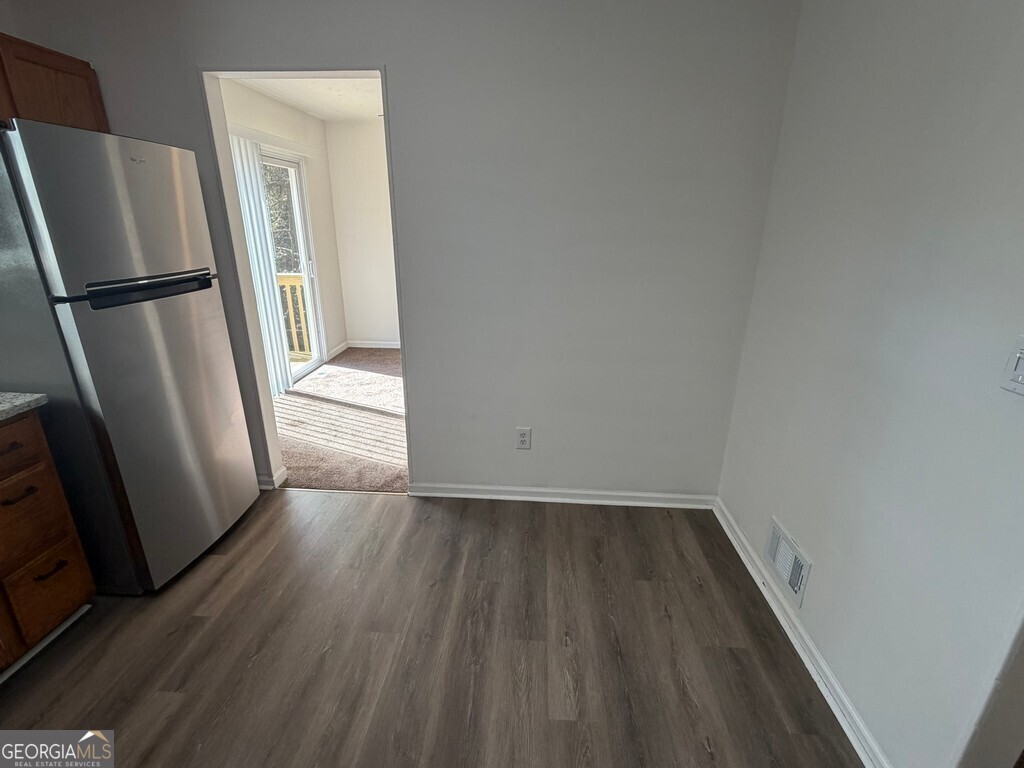 9292 Settlers Grove Road Northeast Covington, GA 30014 - Photo 26 of 110 a view of an empty room with wooden floor and a window