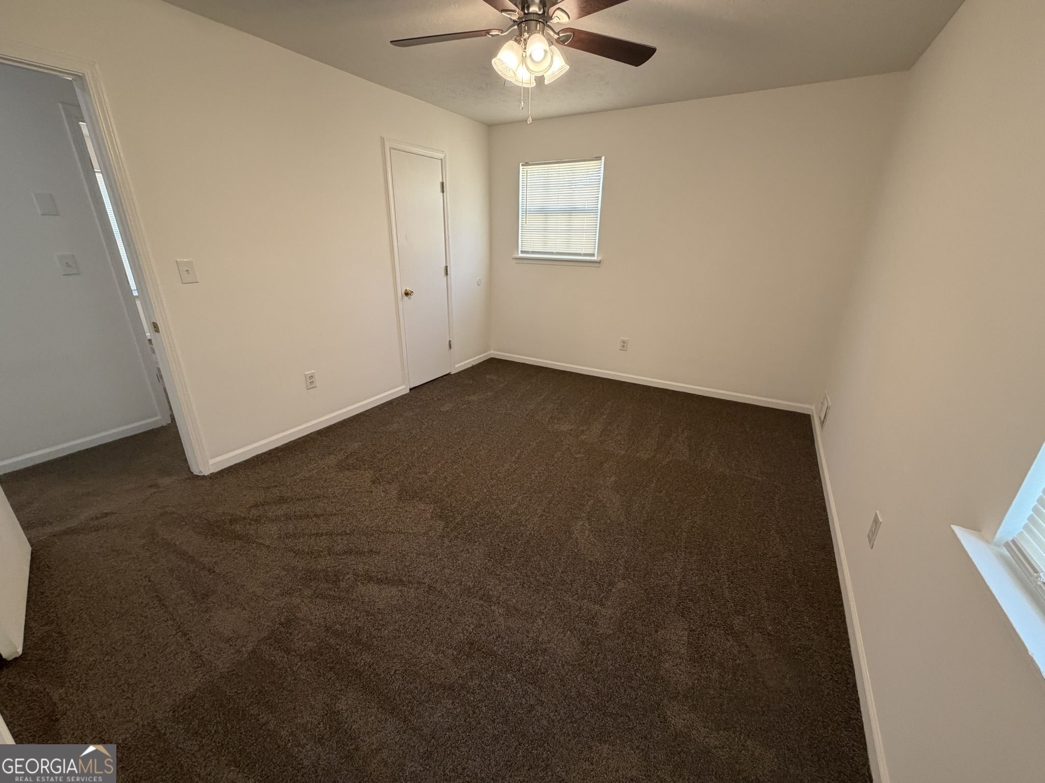 9292 Settlers Grove Road Northeast Covington, GA 30014 - Photo 31 of 110 an empty room with a ceiling fan and a window
