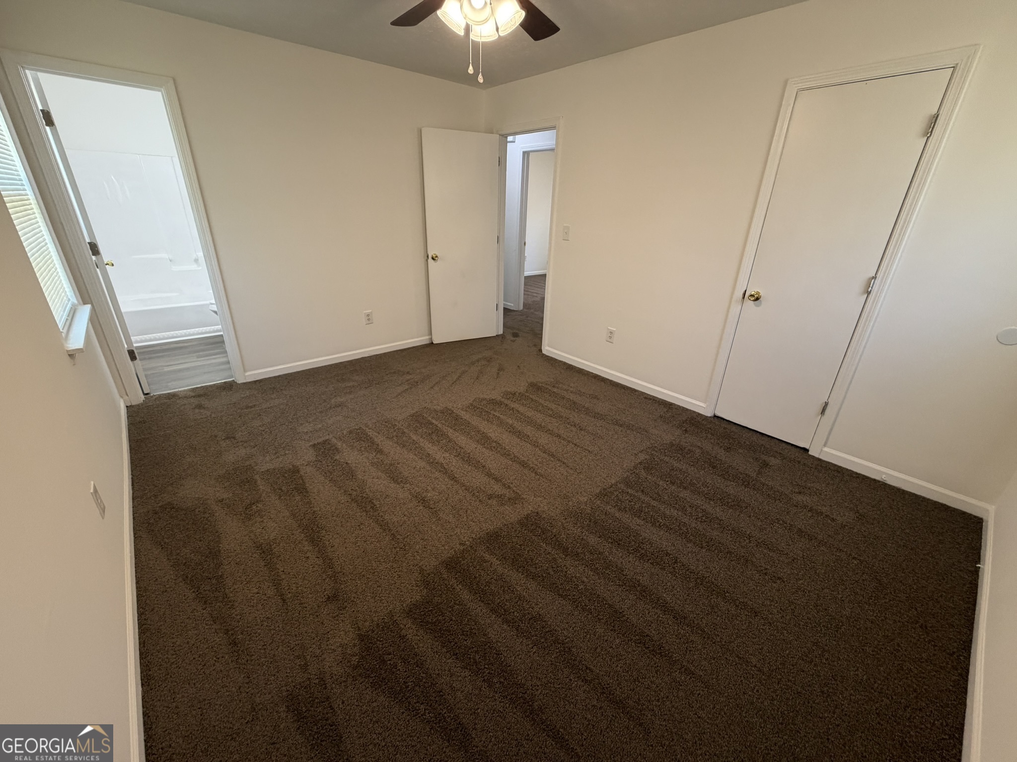 9292 Settlers Grove Road Northeast Covington, GA 30014 - Photo 33 of 110 an empty room with wooden floor and windows