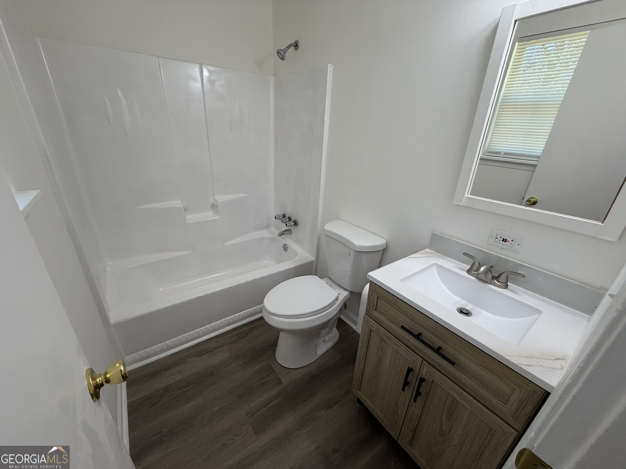 9292 Settlers Grove Road Northeast Covington, GA 30014 - Photo 37 of 110 a bathroom with a toilet sink and mirror