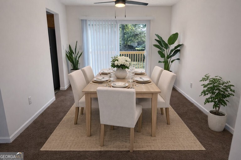 9292 Settlers Grove Road Northeast Covington, GA 30014 - Photo 40 of 110 a dining room with furniture potted plants and wooden floor