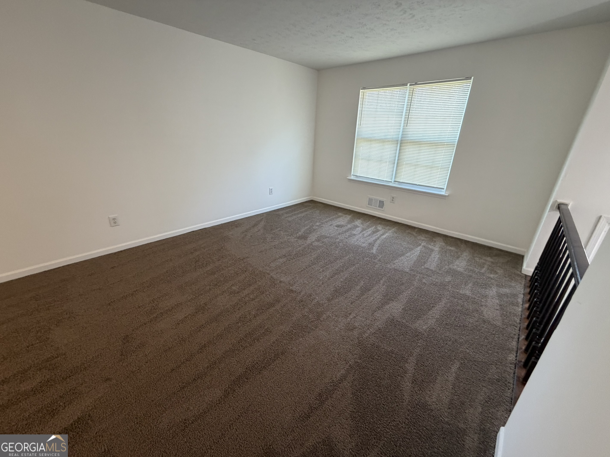 9292 Settlers Grove Road Northeast Covington, GA 30014 - Photo 4 of 110 an empty room with wooden floor and windows