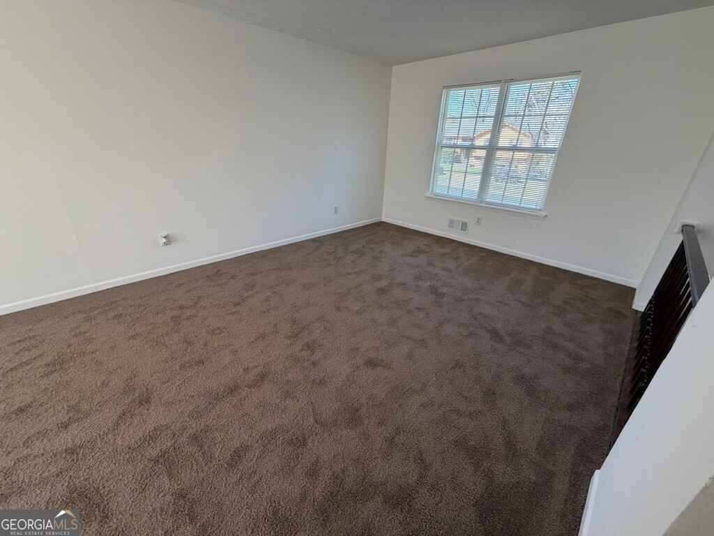 9292 Settlers Grove Road Northeast Covington, GA 30014 - Photo 48 of 110 a view of an empty room with a window