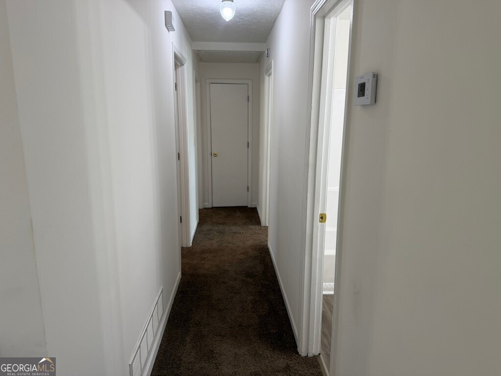 9292 Settlers Grove Road Northeast Covington, GA 30014 - Photo 56 of 110 a view of a hallway with a wooden floor
