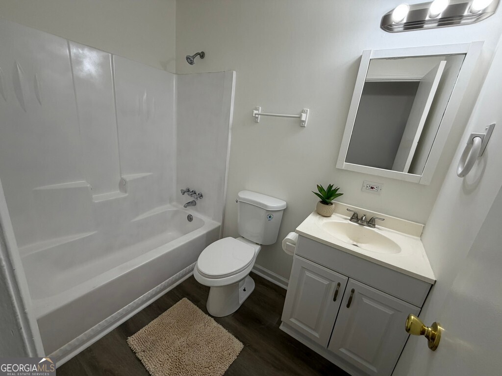 9292 Settlers Grove Road Northeast Covington, GA 30014 - Photo 60 of 110 a bathroom with a sink toilet a mirror and shower