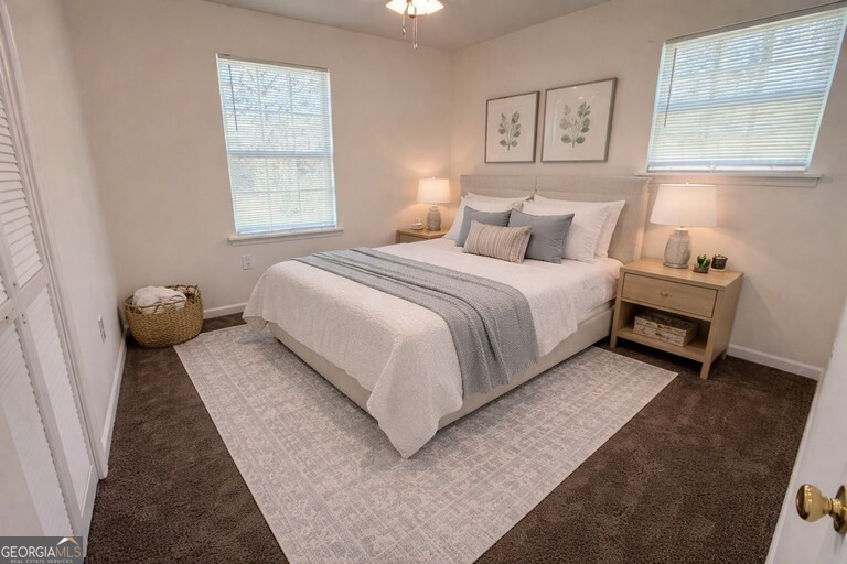 9292 Settlers Grove Road Northeast Covington, GA 30014 - Photo 62 of 110 a bed room with a bed and a night stand