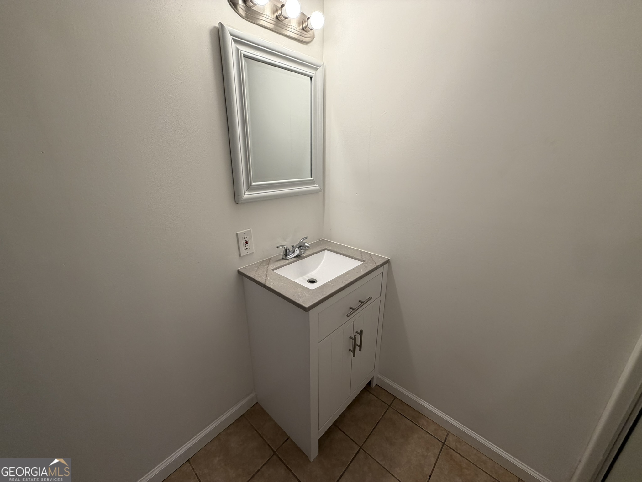 9292 Settlers Grove Road Northeast Covington, GA 30014 - Photo 73 of 110 a utility room with a sink a mirror and vanity