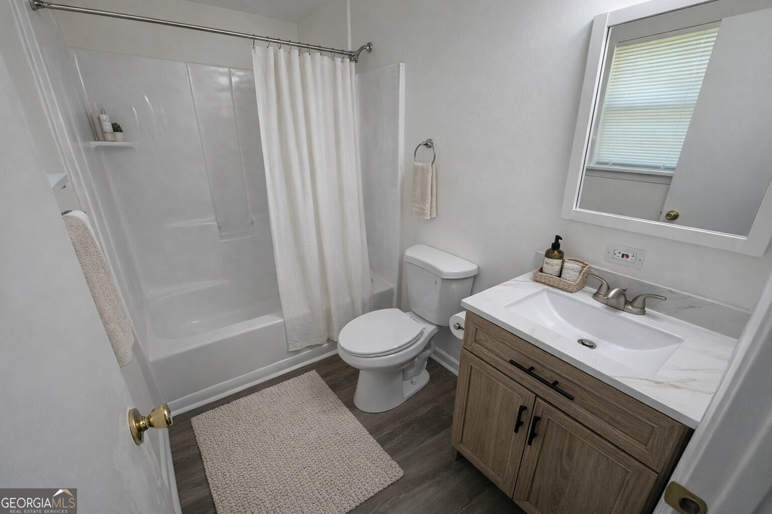 9292 Settlers Grove Road Northeast Covington, GA 30014 - Photo 84 of 110 a bathroom with a sink a toilet and shower