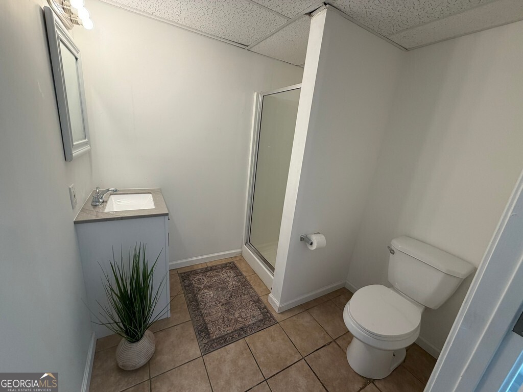 9292 Settlers Grove Road Northeast Covington, GA 30014 - Photo 95 of 110 a bathroom with a toilet and a potted plant