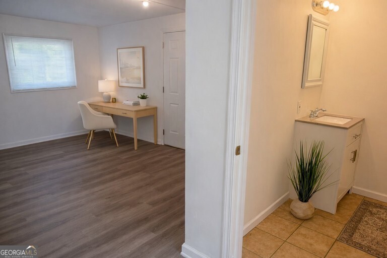 9292 Settlers Grove Road Northeast Covington, GA 30014 - Photo 96 of 110 a dining room with furniture and a potted plant