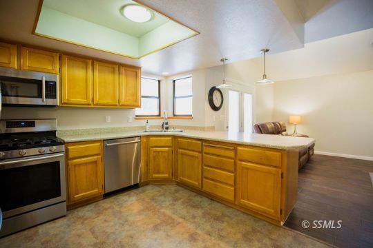 312 East Upjohn Avenue Ridgecrest, CA 93555 - Photo 12 of 35 a kitchen with stainless steel appliances granite countertop a sink a stove a microwave a counter top space and cabinets