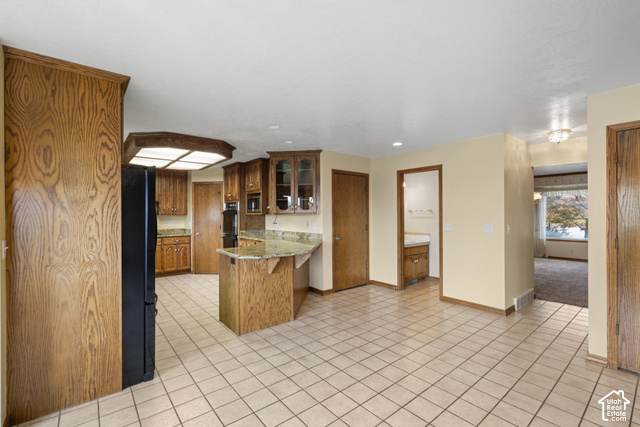 1373 Pheasant Ridge Circle Bountiful, UT 84010 - Photo 13 of 50 Kitchen featuring wood cabinetry, solid surface countertops, a built-in oven, and tile flooring