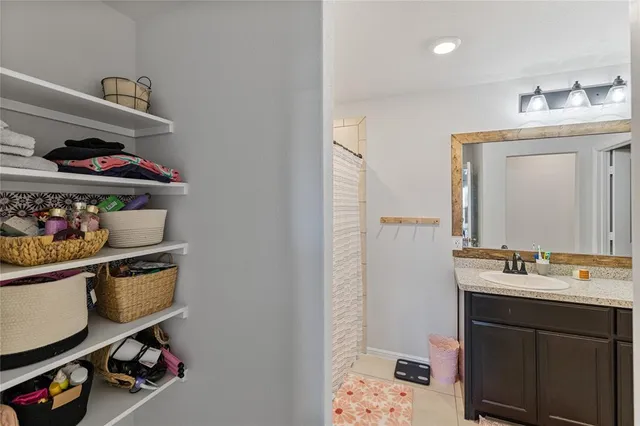 a view of walk in closet with clothes