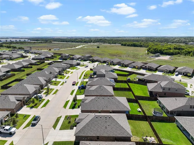 aerial view of a house with a yard